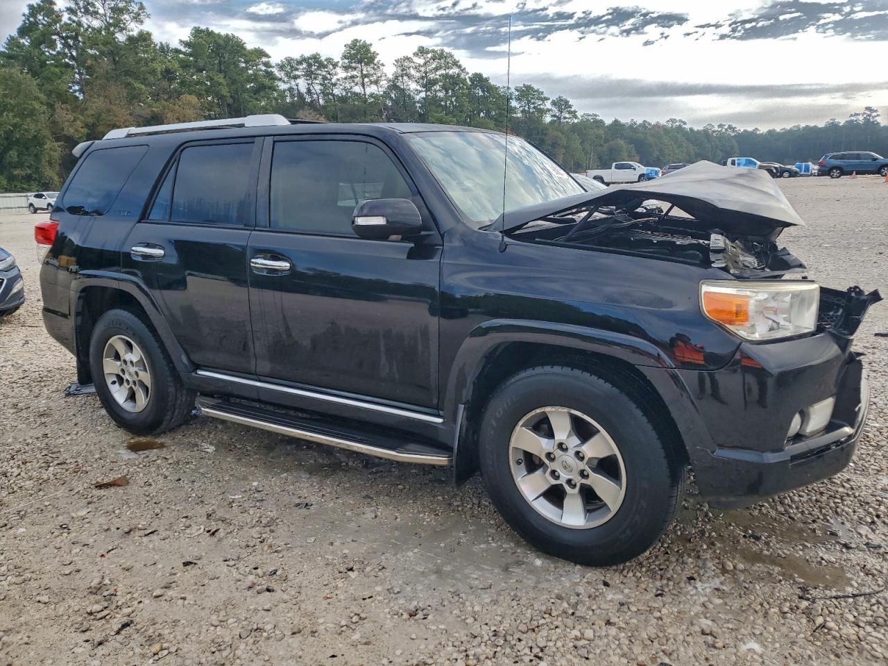Totaled vehicle with front-end damage in salvage yard