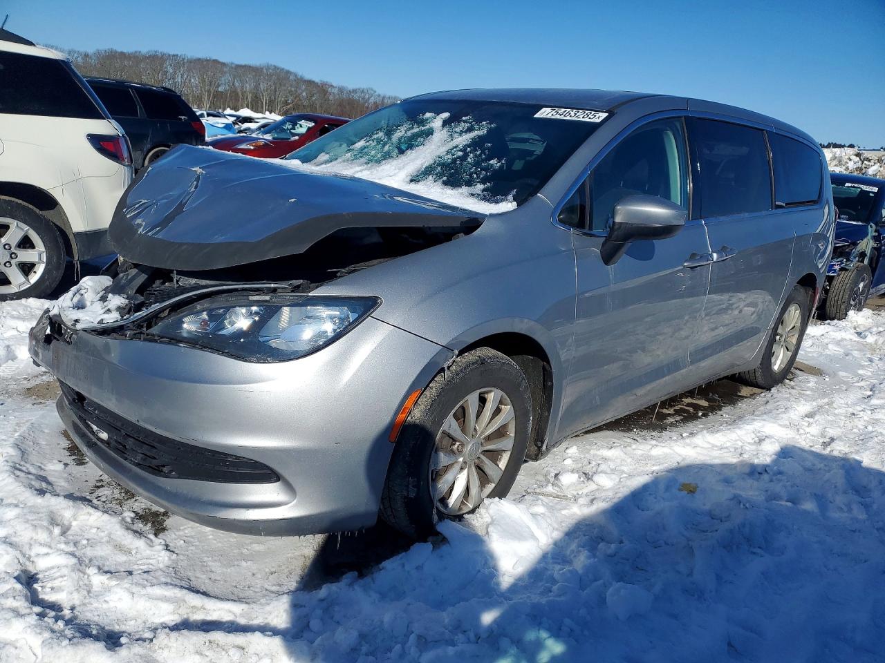 A black 2019 Honda Civic EX sedan with severe front-end collision damage and deployed airbag at a tow yard